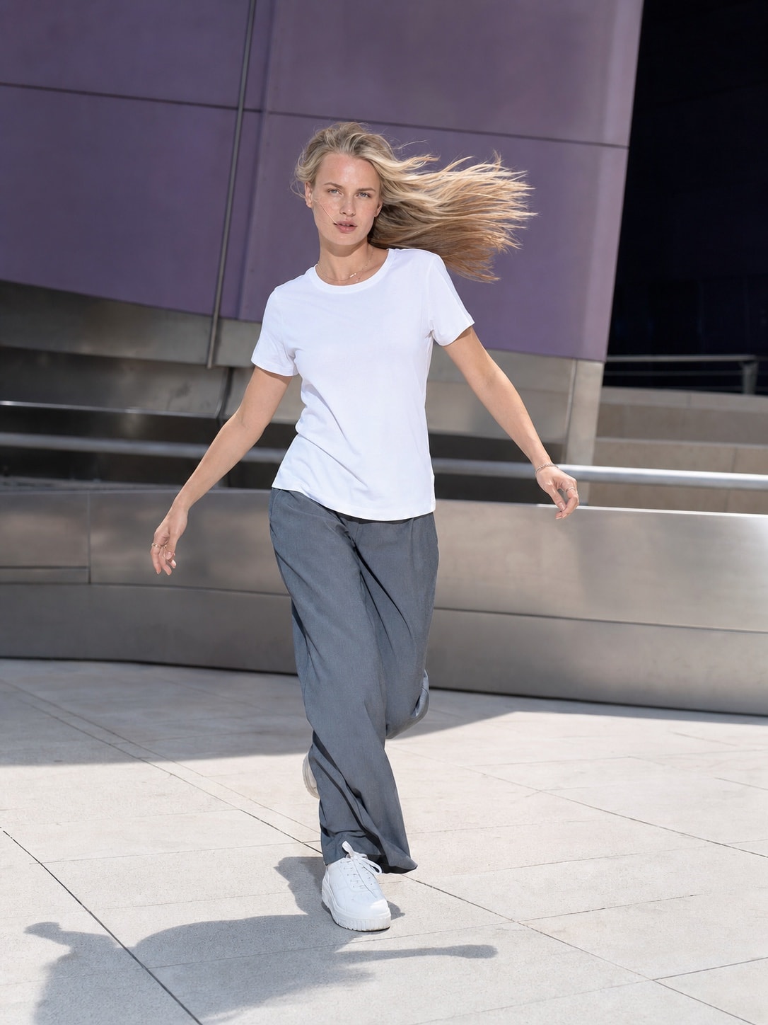 Blonde Slavic woman wearing the white T-shirt in a dynamic city scene