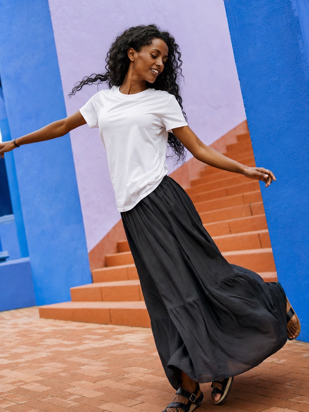 Ethiopian woman wearing the white T-shirt in a dynamic lifestyle scene