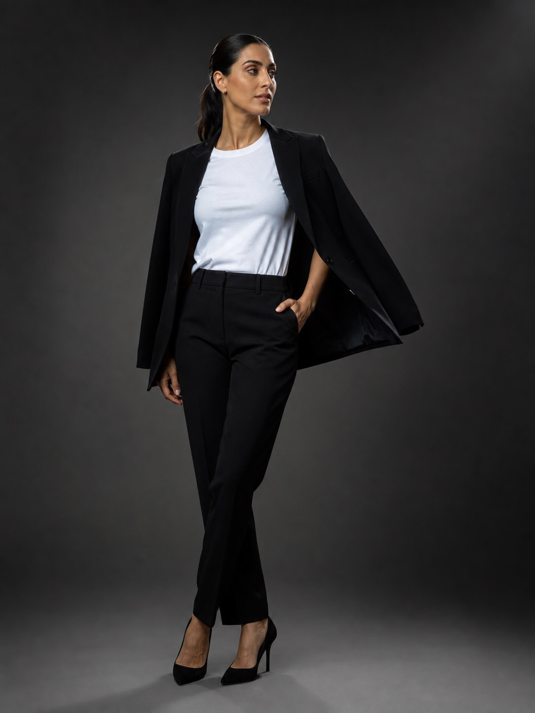 Middle Eastern woman styling the white T-shirt with a formal black suit