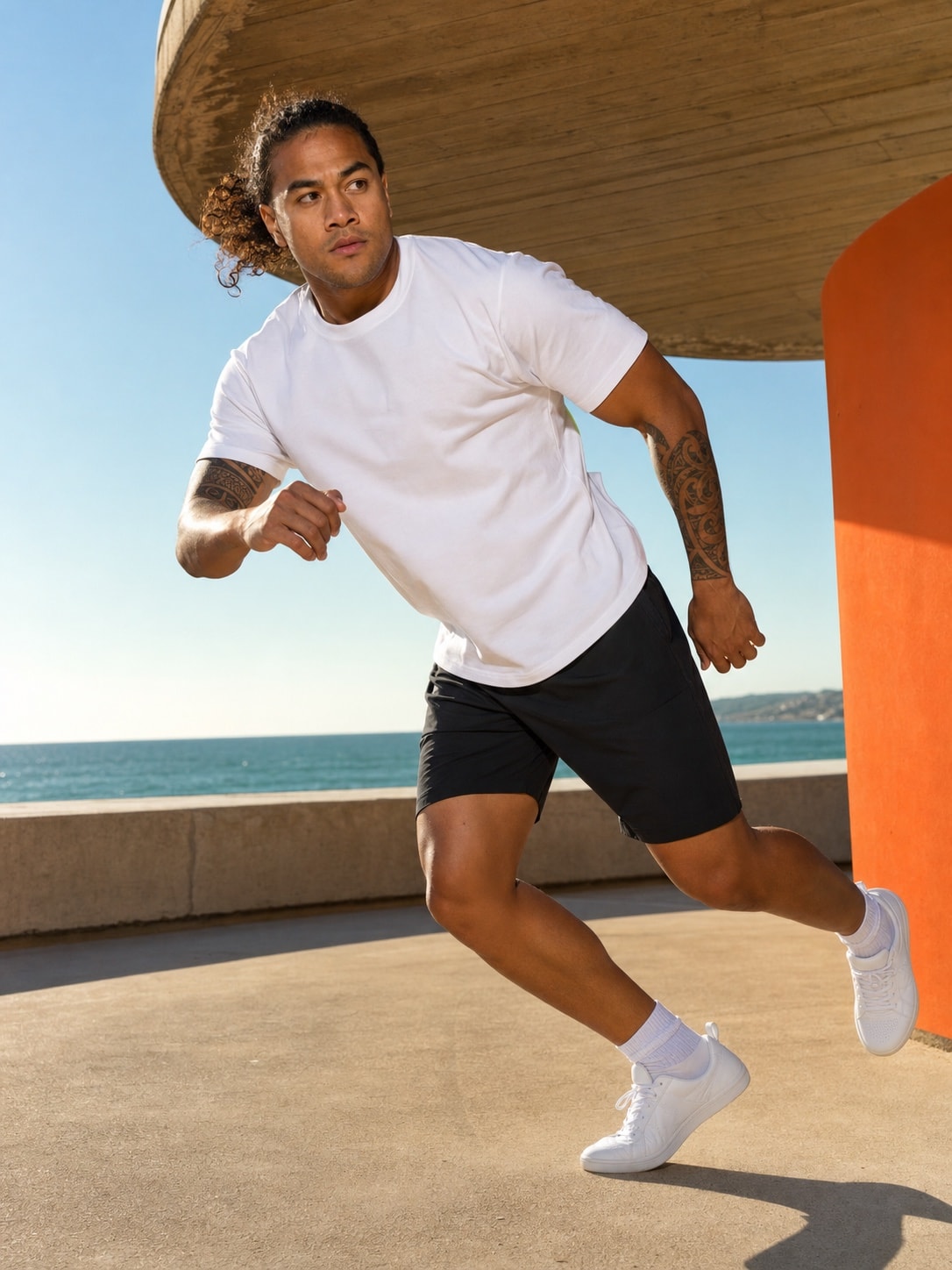 Polynesian male model wearing the white T-shirt in motion